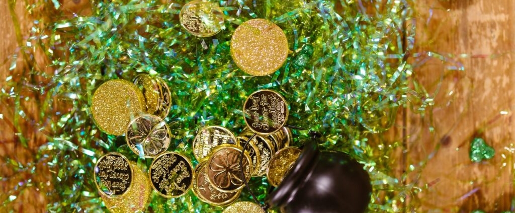 pot of gold coins spilt on top of green packaging